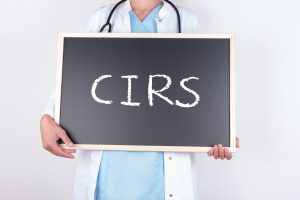 doctor holding chalkboard with CIRS written on it.